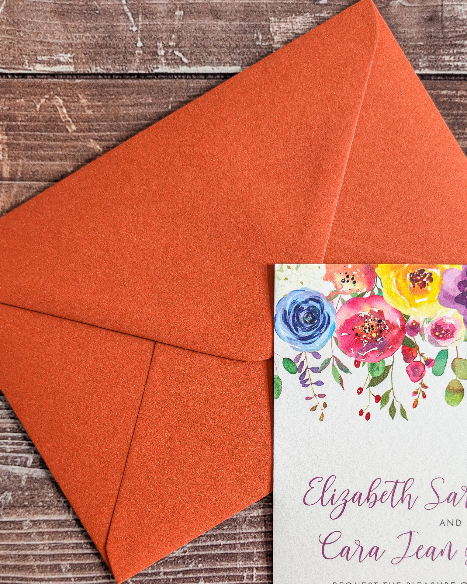 Vibrant orange envelopes for a colourful semi-custom invitation design