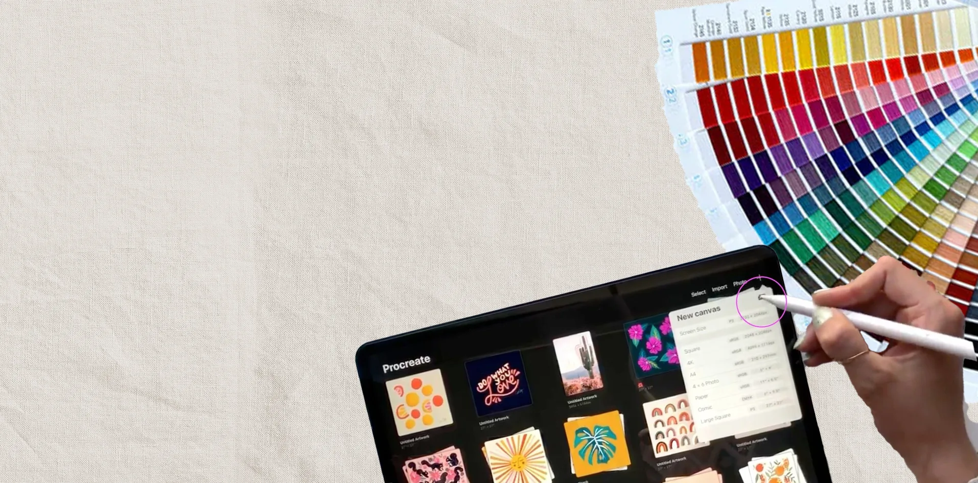Becky illustrating the Royal Liver Building on a tablet with Pantone colour swatches