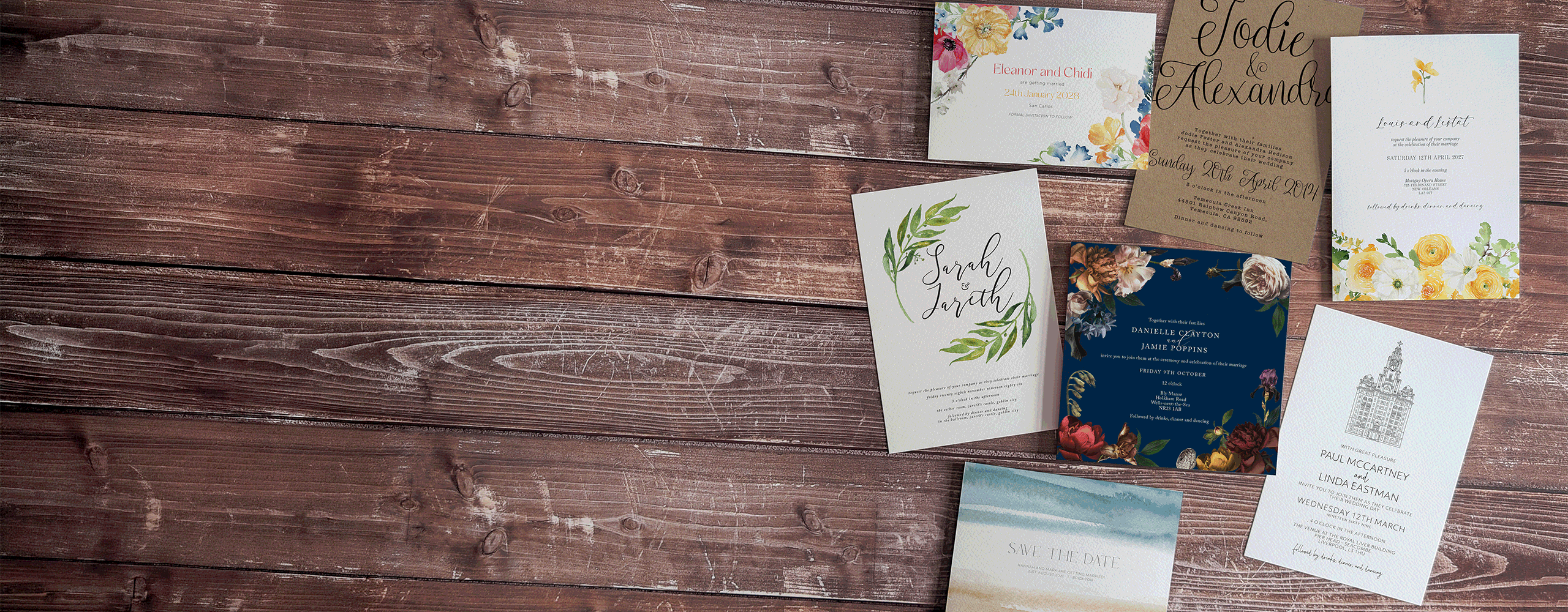 A collection of Hawthorne and Ivory wedding stationery designs laid out on a wooden table